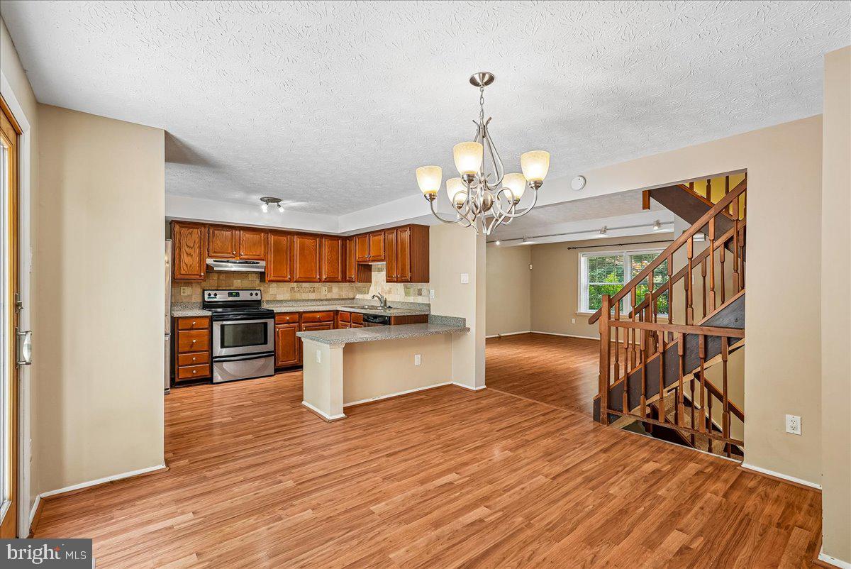 2331 Middle Creek Lane Reston, VA 20191 - Photo 18 of 78 a view of a kitchen center island wooden floor and stainless steel appliances