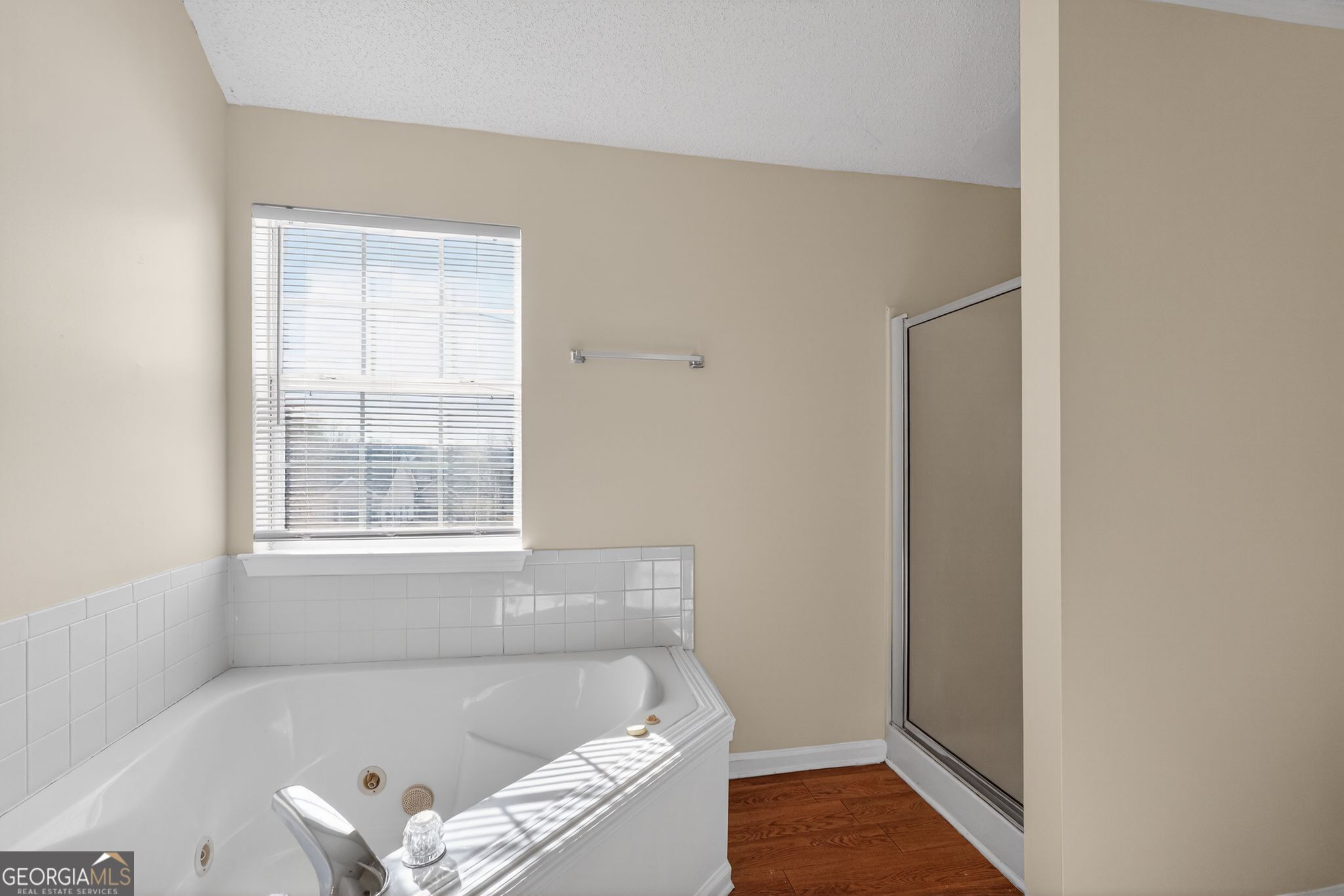 4627 Laura Place Lithonia, GA 30038 - Photo 23 of 33 a white bath tub sitting in a bathroom next to a window