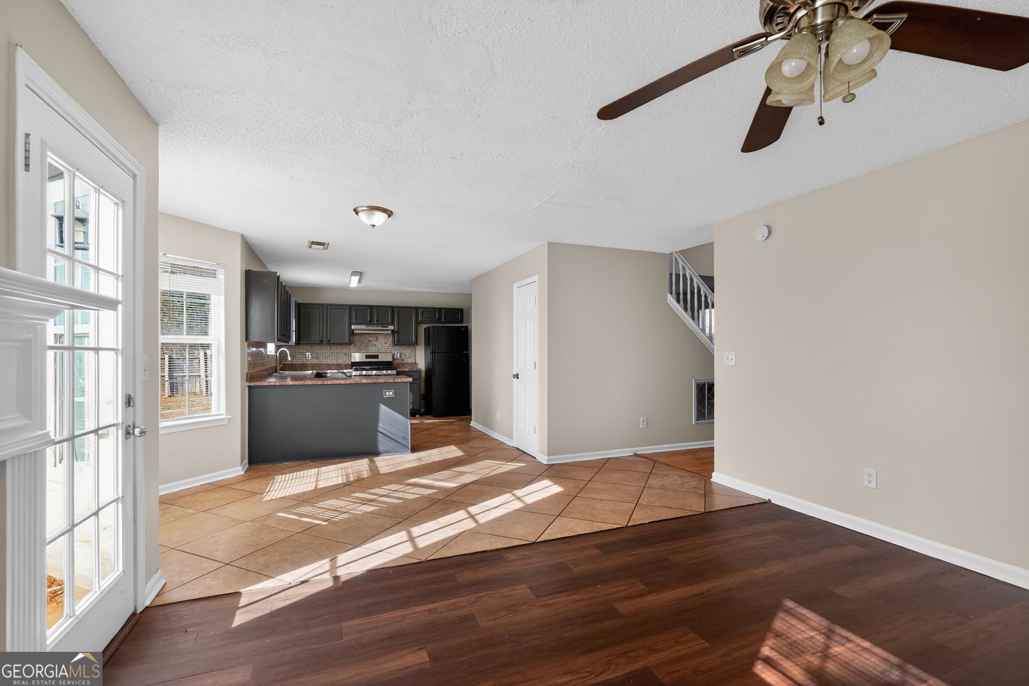 4627 Laura Place Lithonia, GA 30038 - Photo 5 of 33 a view of kitchen and empty room with wooden floor