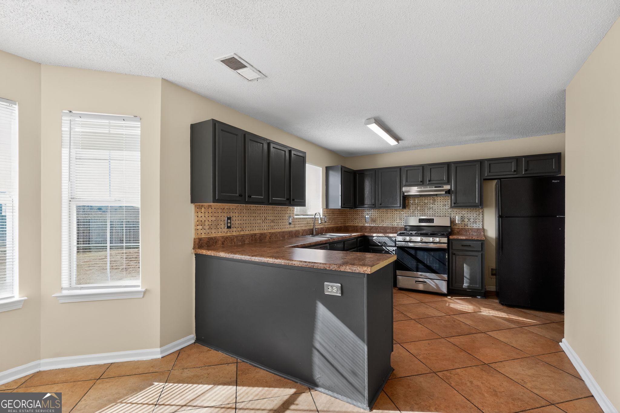 4627 Laura Place Lithonia, GA 30038 - Photo 6 of 33 a kitchen with stainless steel appliances granite countertop a stove top oven a sink dishwasher and a refrigerator
