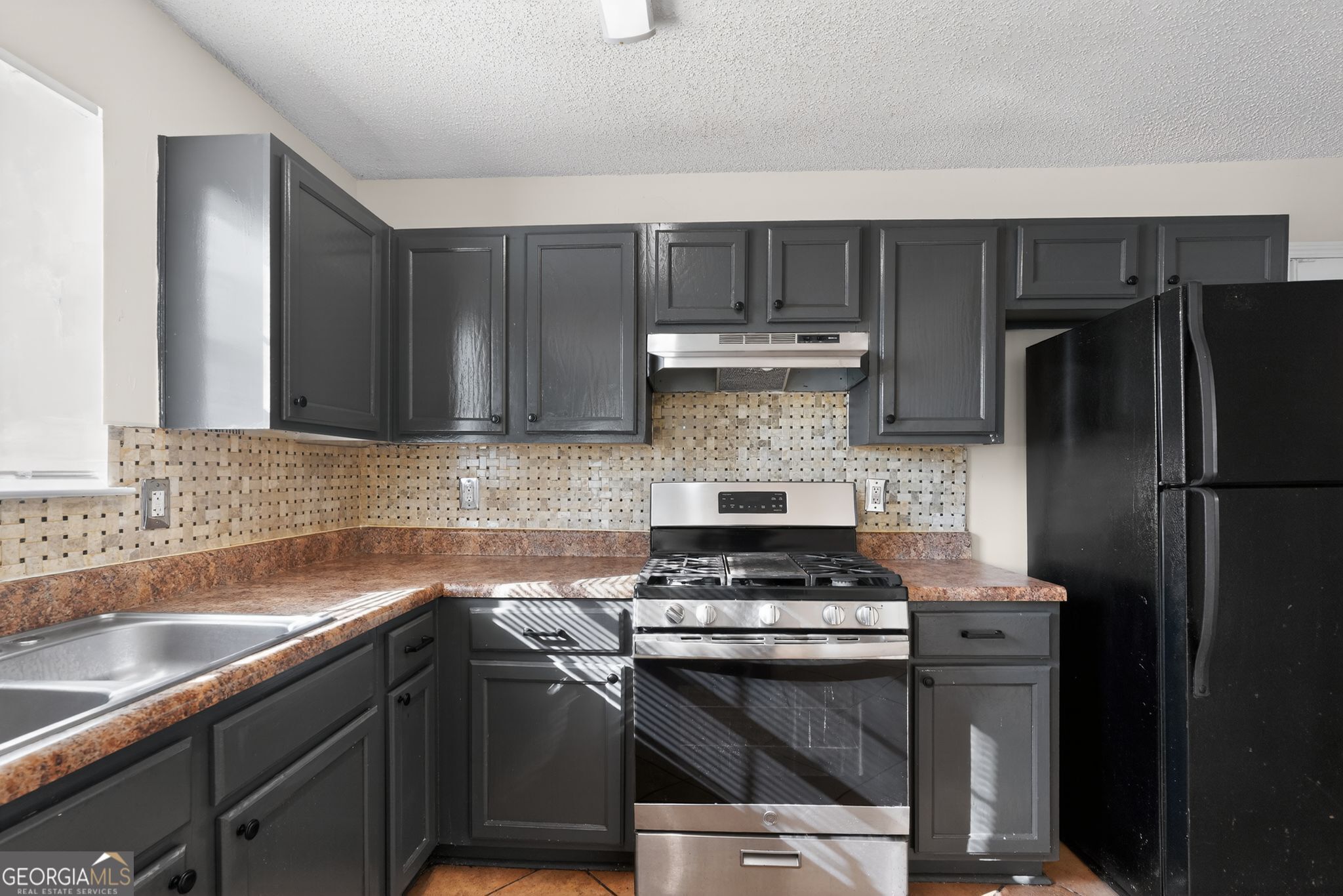 4627 Laura Place Lithonia, GA 30038 - Photo 7 of 33 a kitchen with a sink stove and refrigerator