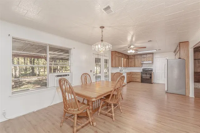 a dining room with furniture window and wooden floor