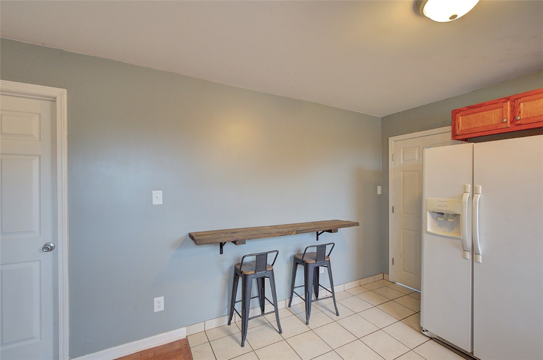 325 Rock Quarry Road Travelers Rest, SC 29690 - Photo 12 of 37 This cozy kitchen area features a convenient breakfast bar, perfect for casual dining and morning coffee.