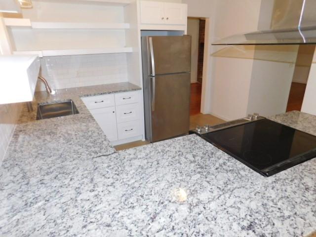 1710 Pine Road Marietta, GA 30062 - Photo 6 of 23 a kitchen with a refrigerator and a stove
