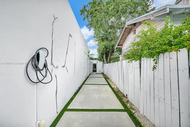 a view of a backyard with a wooden fence