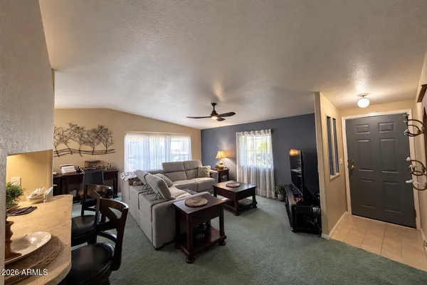 a living room with furniture a chandelier and a window