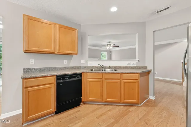 a kitchen with granite countertop cabinets and appliances