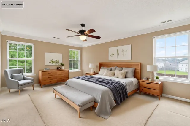 a spacious bedroom with a large bed couch and a large window