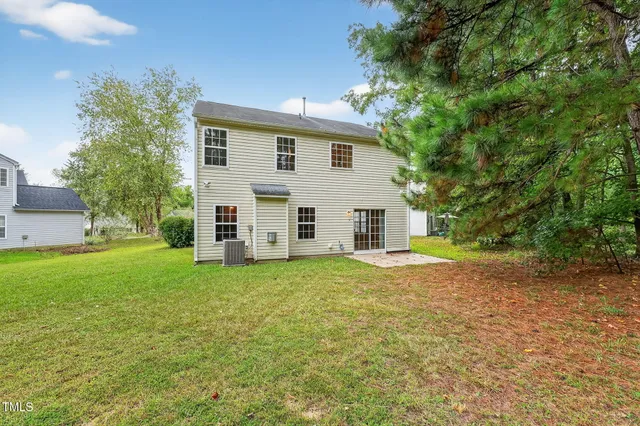 a view of a backyard with large trees