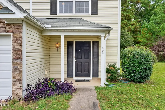 a view of a house with potted plants