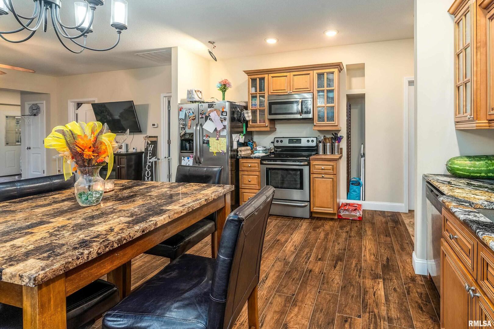 2018 Clarke Street Murphysboro, IL 62966 - Photo 11 of 18 a kitchen with stainless steel appliances granite countertop a stove refrigerator and a fireplace