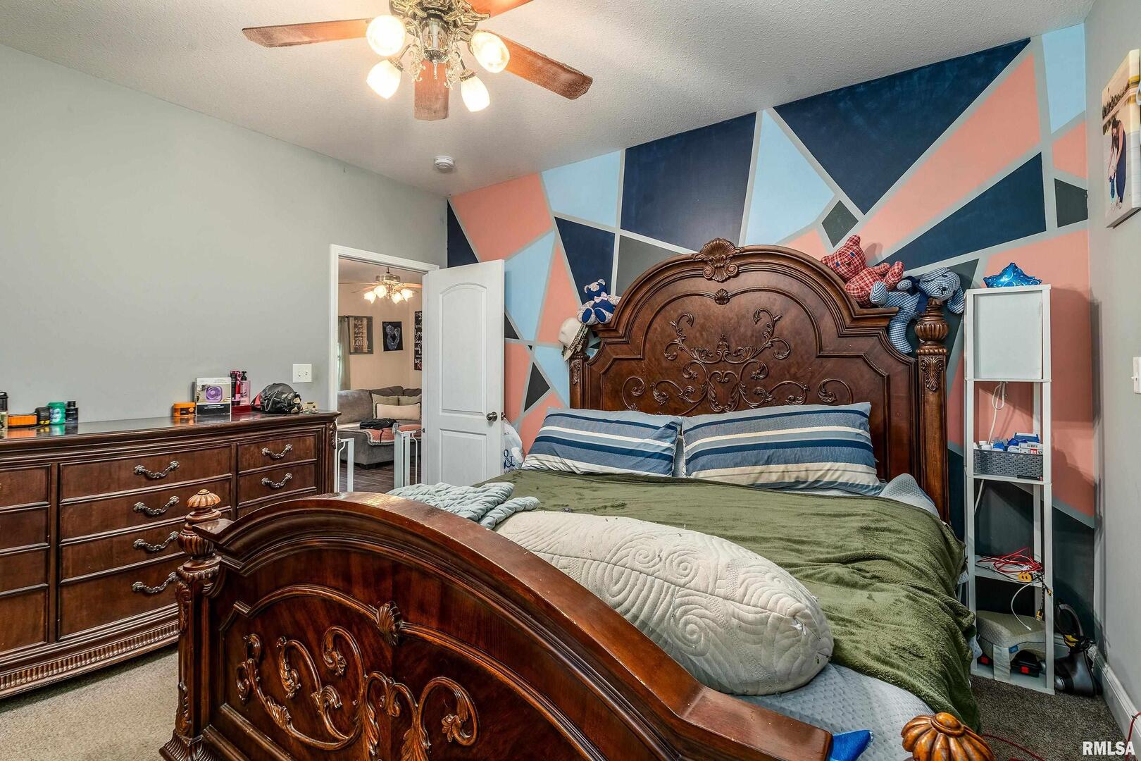 2018 Clarke Street Murphysboro, IL 62966 - Photo 13 of 18 a bedroom with a bed and a chandelier