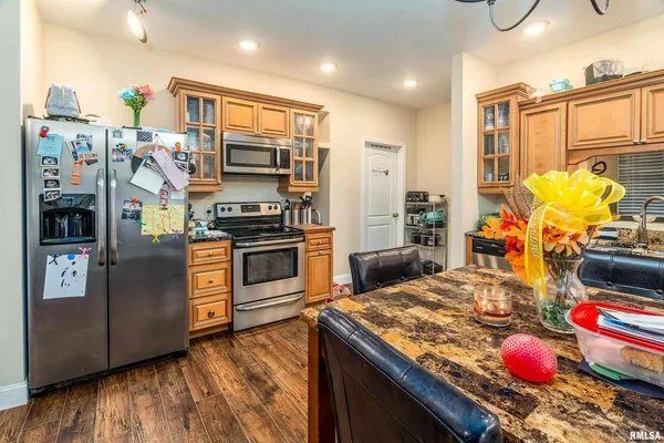 a kitchen with stainless steel appliances granite countertop a stove a sink and a refrigerator