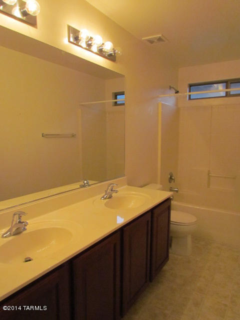 669 West Ash Ridge Drive Green Valley, AZ 85614 - Photo 11 of 17 a bathroom with a sink and a mirror