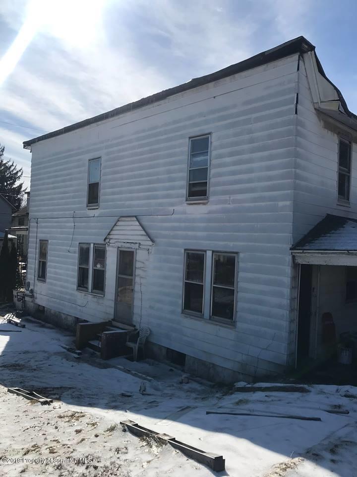2435 Heerman Avenue Scranton, PA 18509 - Photo 3 of 6 a brick house with a yard