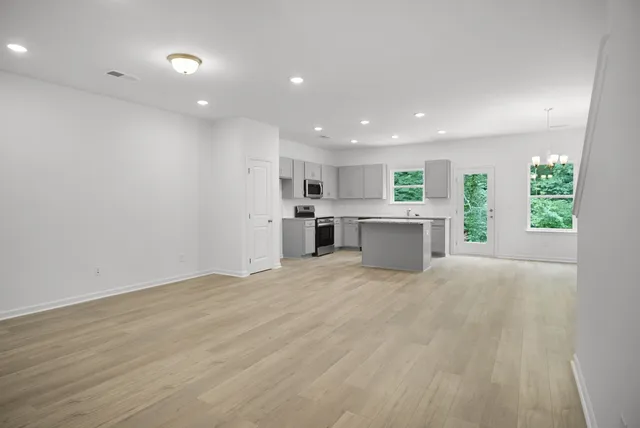 a view of a kitchen with a sink and white cabinets