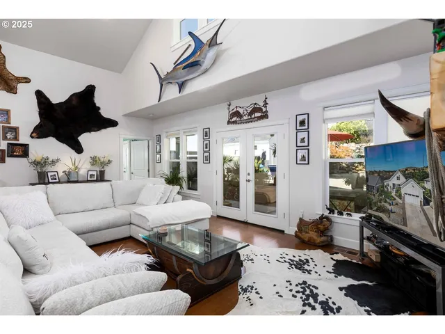 a living room with furniture wooden floor and a large window