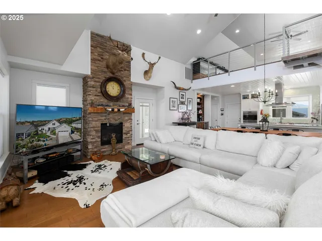 a living room with furniture a fireplace kitchen view and a fireplace