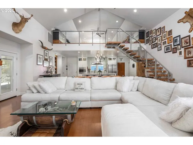 a living room with furniture and a chandelier
