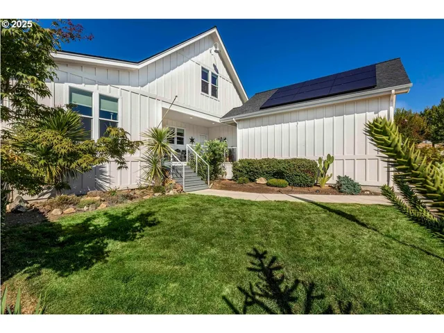 a backyard of a house with a garden and plants