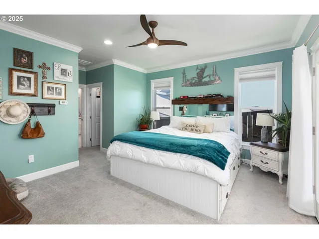 a bedroom with a large bed and a chandelier