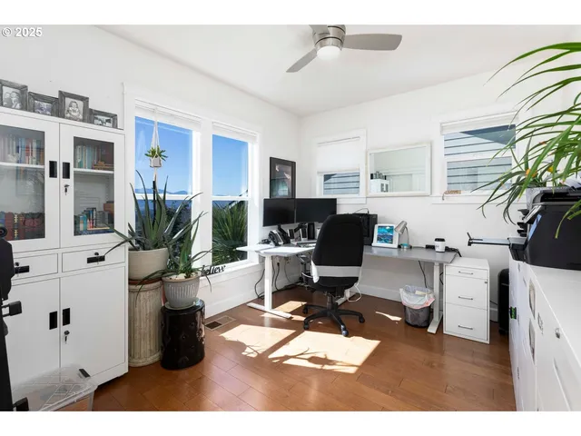 a living room with furniture a flat screen tv and a potted plant