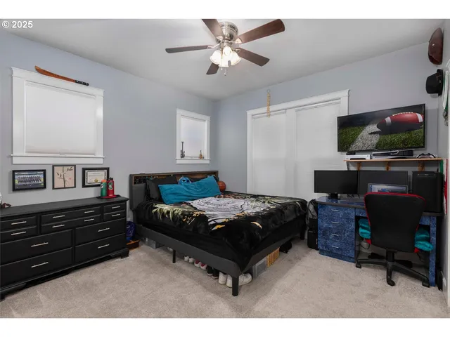 a bedroom with furniture and a flat screen tv