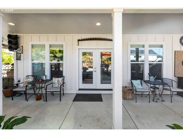 a living room with furniture and large windows