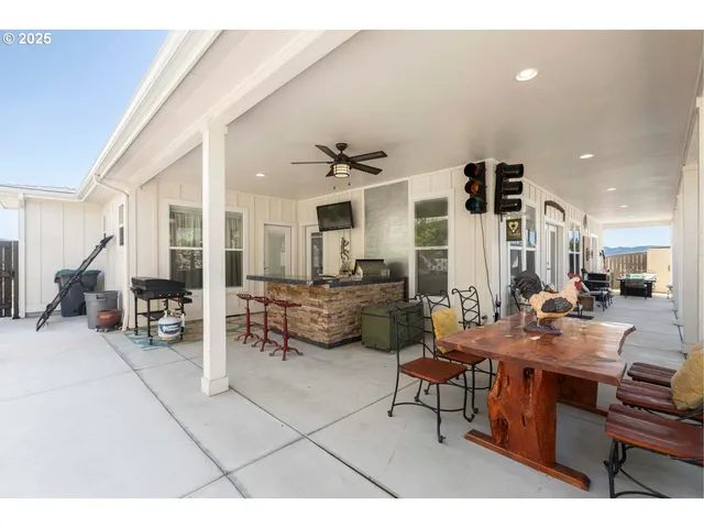a living room with furniture a flat screen tv and a table