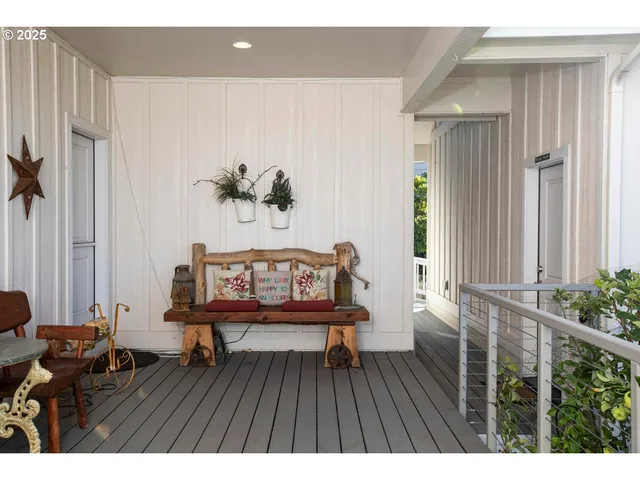 a balcony with wooden floor and bench