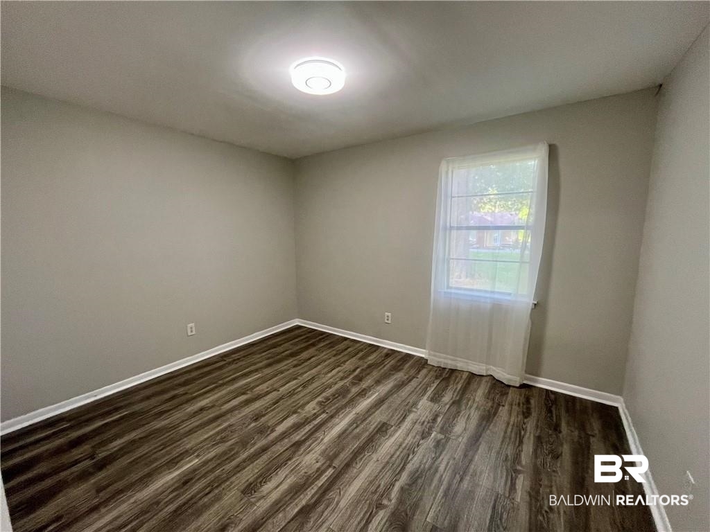 8636 Boe Road Irvington, AL 36544 - Photo 19 of 22 Unfurnished room with dark wood-type flooring and baseboards