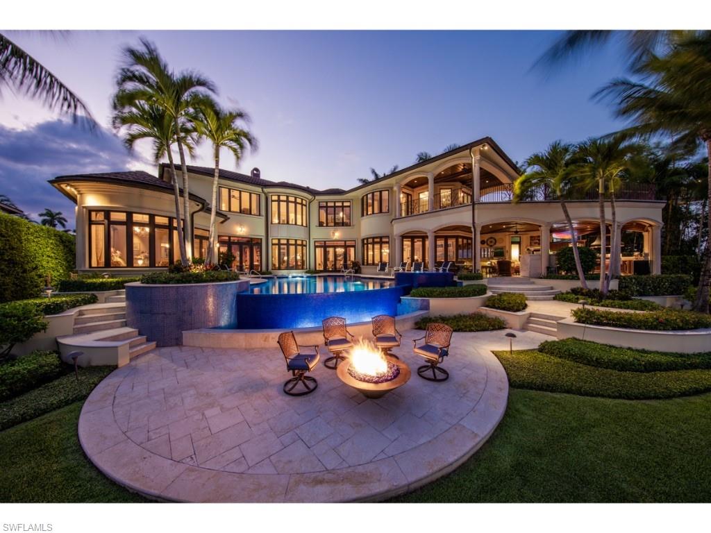 980 Aqua Circle Naples, FL 34102 - Photo 1 of 19 a view of a house with swimming pool and sitting area