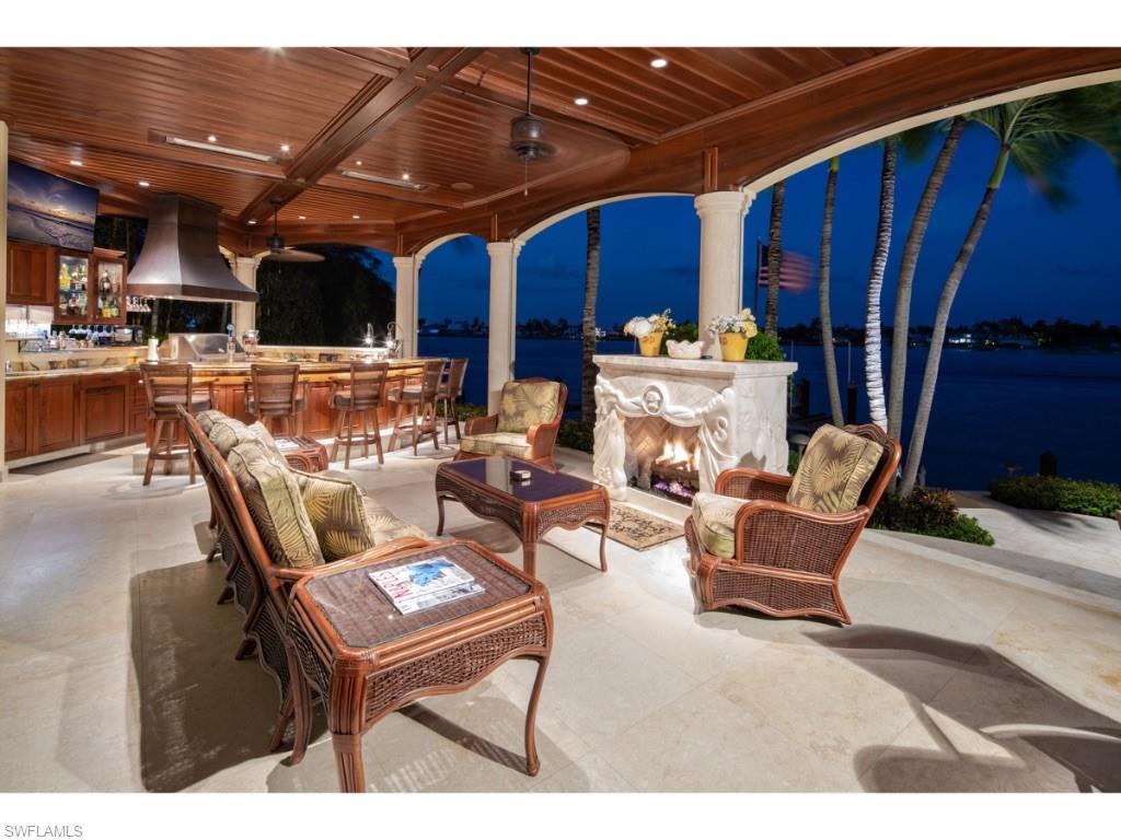 980 Aqua Circle Naples, FL 34102 - Photo 13 of 19 a patio with a table and chairs