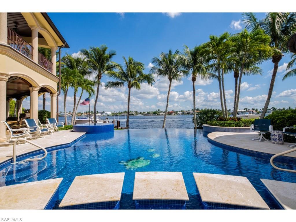 980 Aqua Circle Naples, FL 34102 - Photo 14 of 19 a view of a swimming pool with chairs