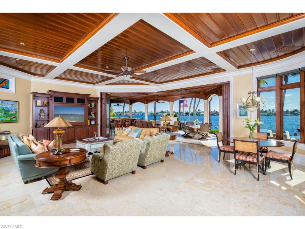 980 Aqua Circle Naples, FL 34102 - Photo 2 of 19 a living room with furniture a fireplace and a large window
