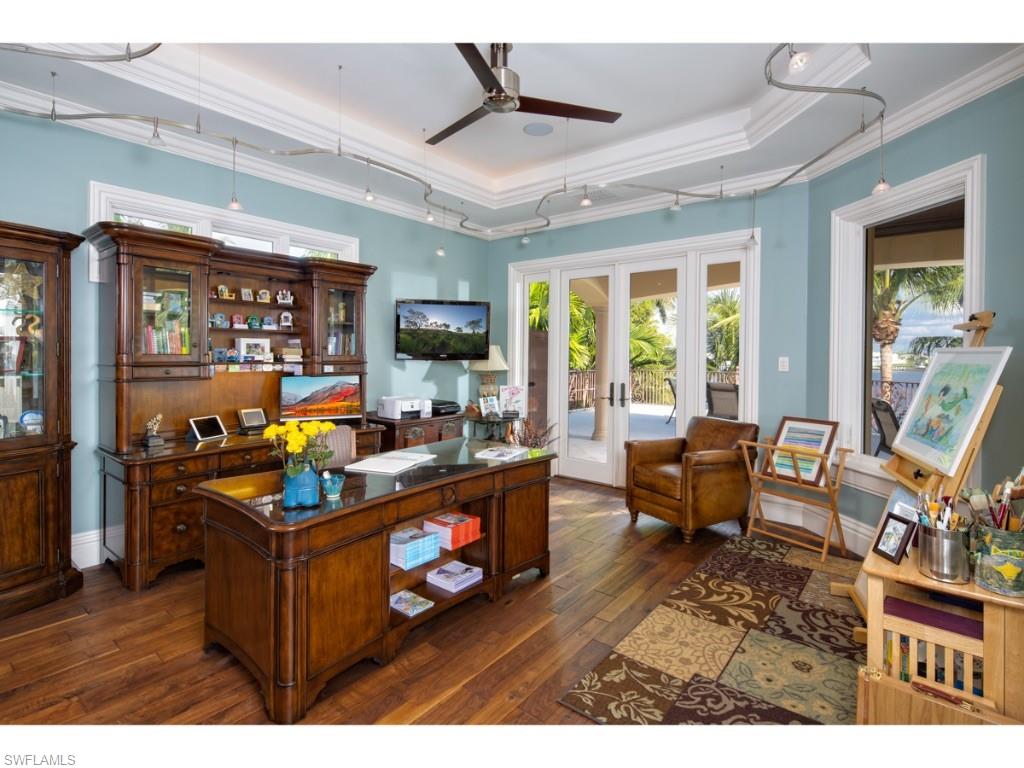 980 Aqua Circle Naples, FL 34102 - Photo 10 of 19 a living room filled with furniture and a flat screen tv