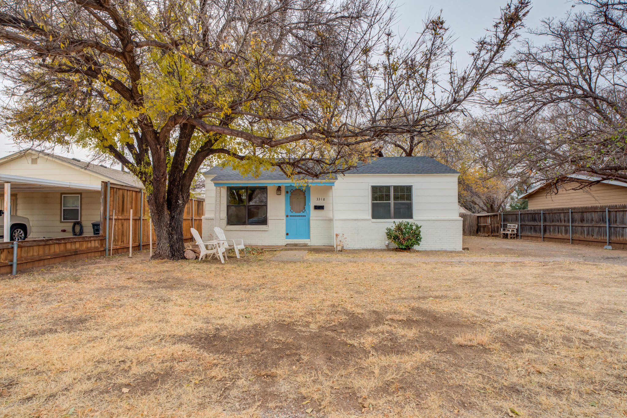 3318 36th Street Lubbock, TX 79413 - Photo 1 of 22 a front view of house with yard and trees in the background
