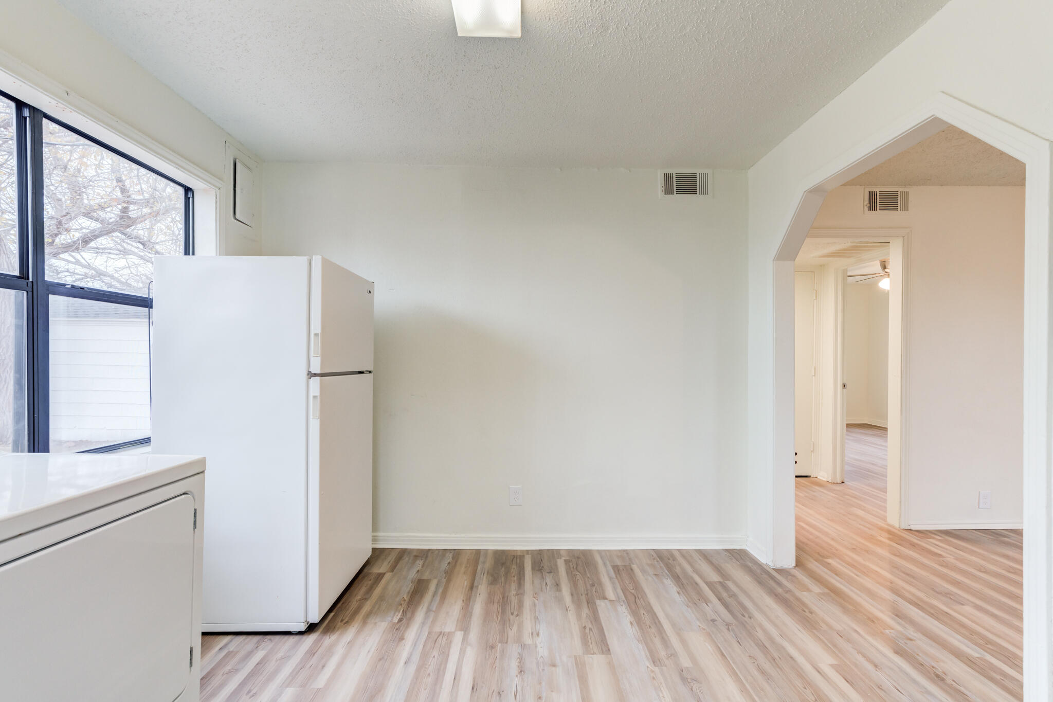 3318 36th Street Lubbock, TX 79413 - Photo 13 of 22 a view of empty room with wooden floor and window