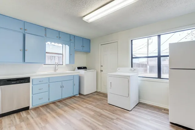 a kitchen with sink cabinets and wooden floor