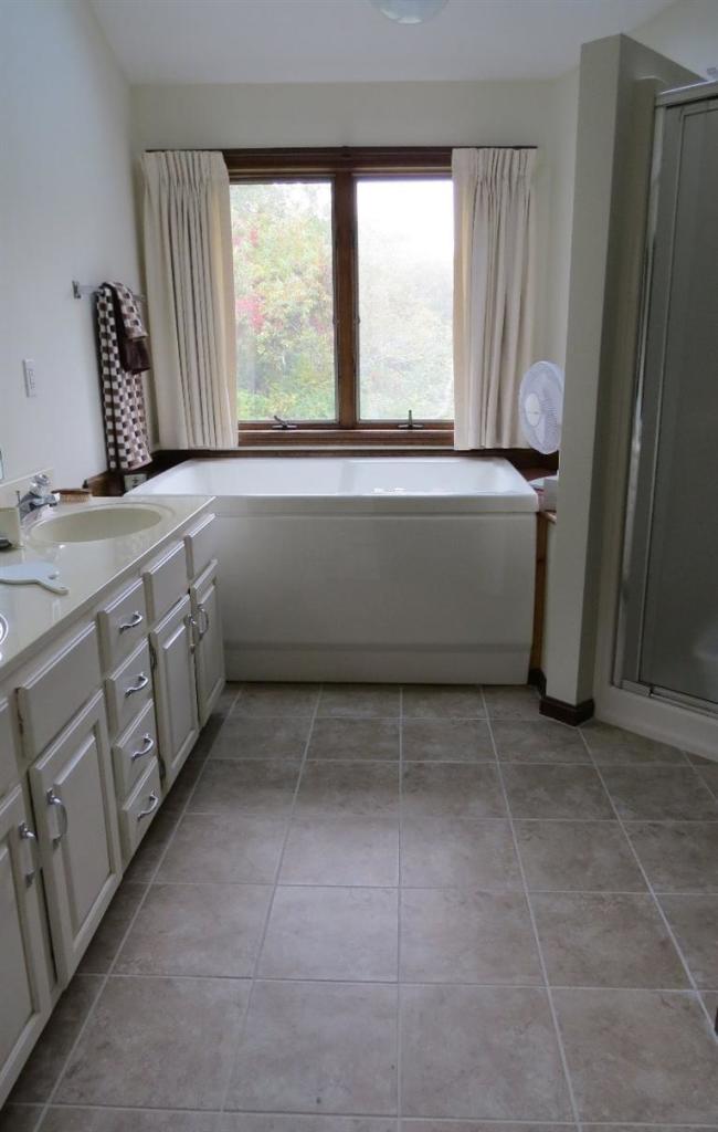 3 Arrowhead Farm Road Truro, MA 02666 - Photo 12 of 35 a bathroom with a bathtub and a window