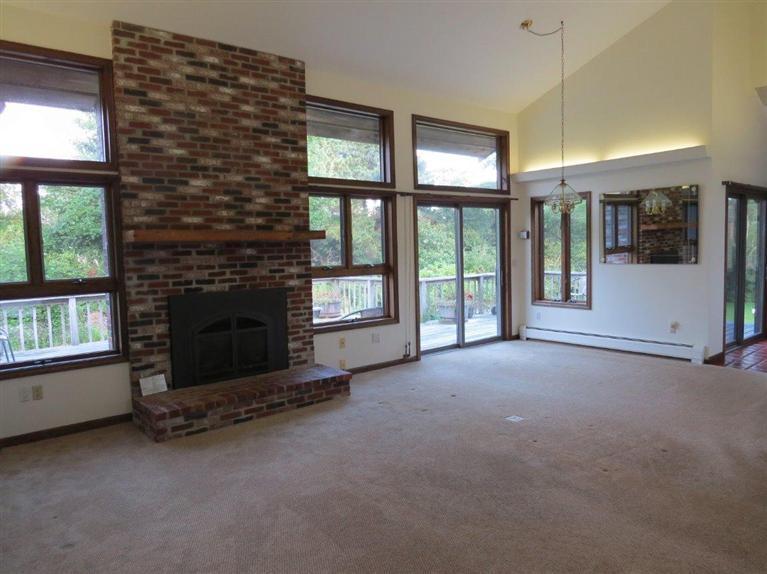 3 Arrowhead Farm Road Truro, MA 02666 - Photo 2 of 35 an empty room with windows and fireplace