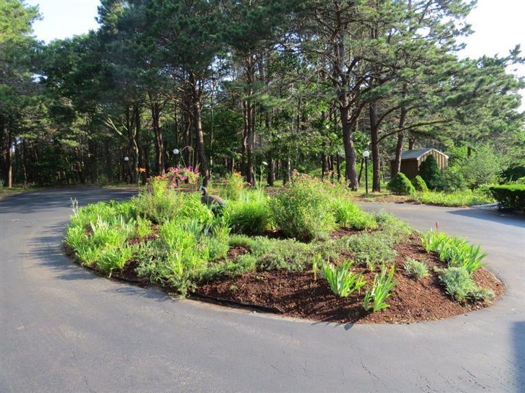 3 Arrowhead Farm Road Truro, MA 02666 - Photo 27 of 35 a view of a garden with a bench