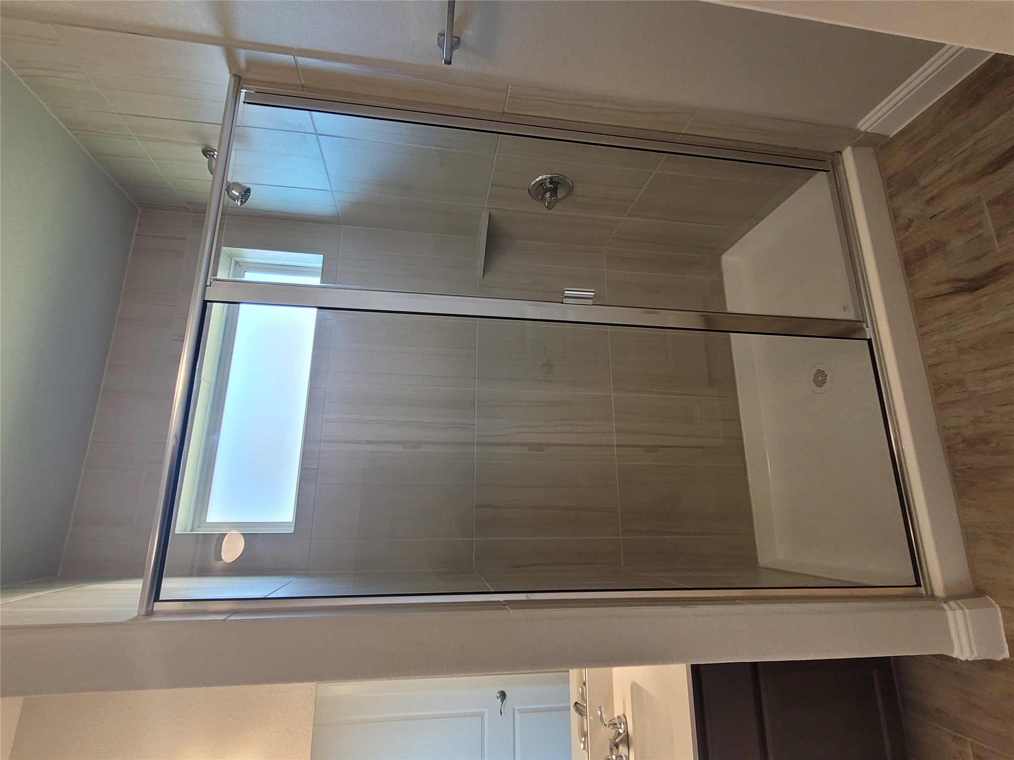 120 Free Stone Drive Georgetown, TX 78628 - Photo 14 of 40 A well-appointed shower stall features sleek glass doors and elegant tile work, offering a rejuvenating daily ritual.