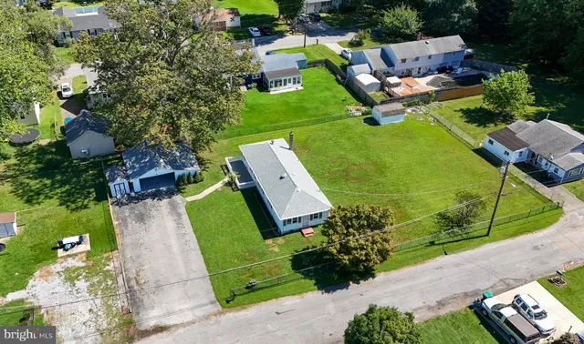 an aerial view of a house with garden space and street view