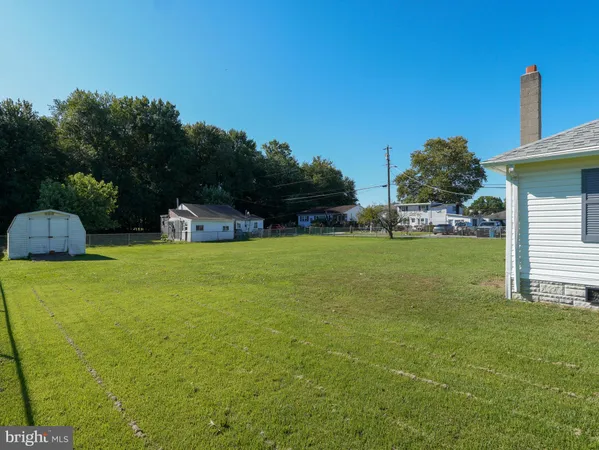 a view of a house with backyard space and sitting area