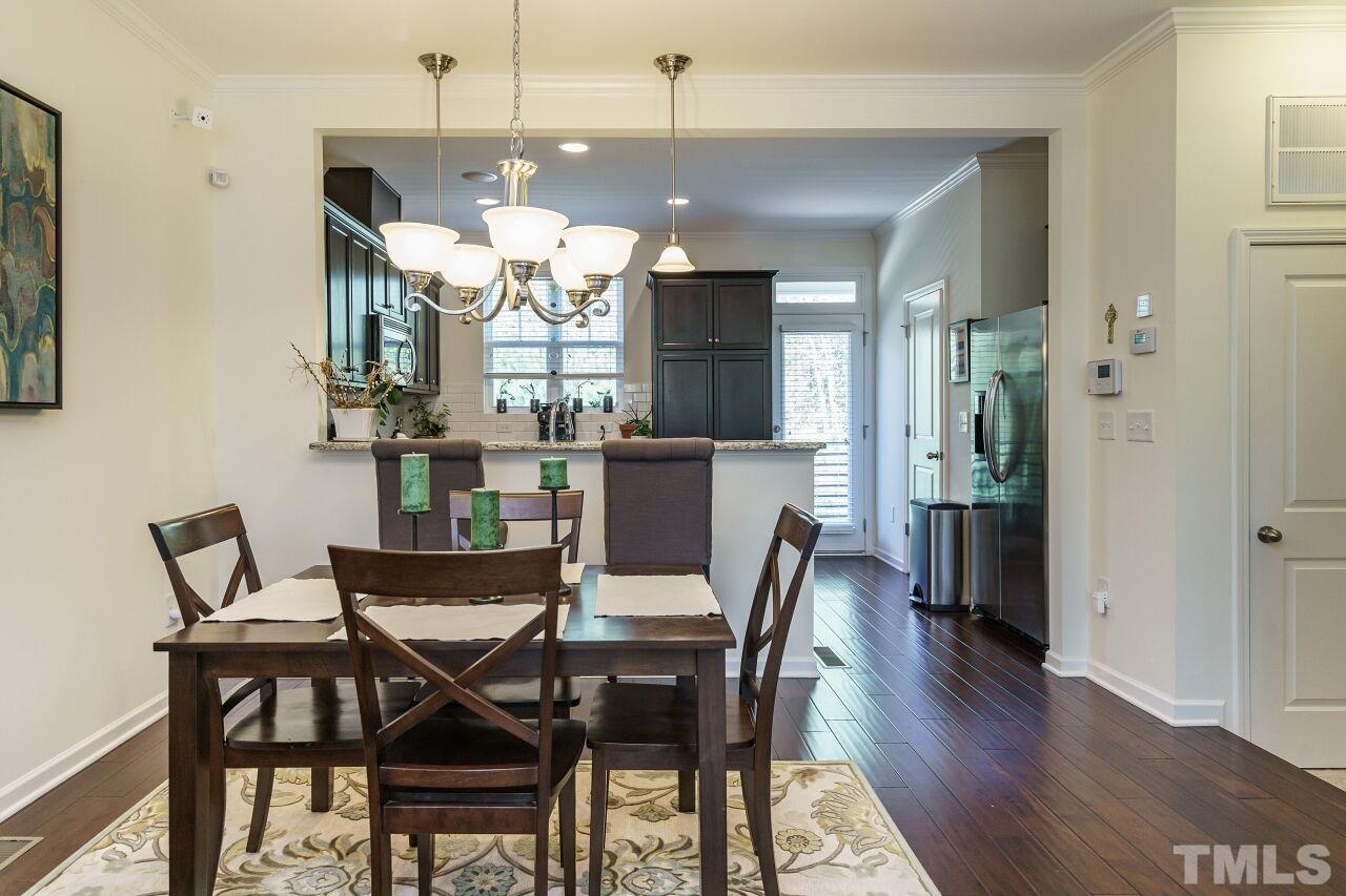 1533 Crafton Way Raleigh, NC 27607 - Photo 11 of 28 a view of a dining room with furniture and wooden floor