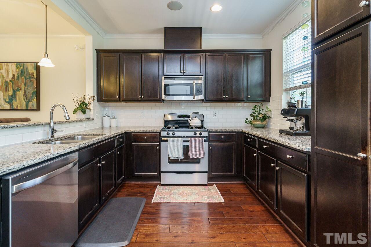 1533 Crafton Way Raleigh, NC 27607 - Photo 14 of 28 a kitchen with a sink stove and refrigerator