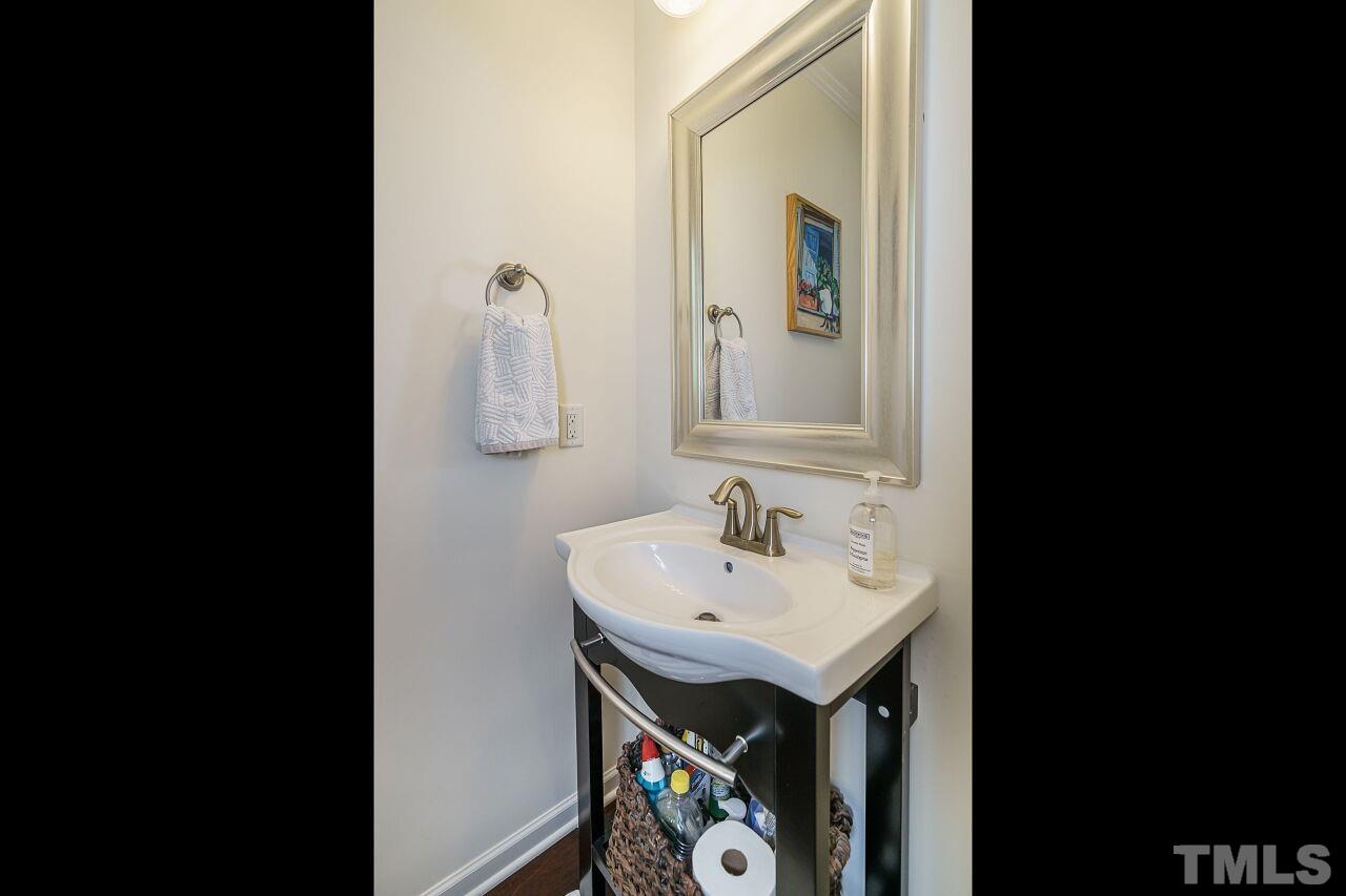 1533 Crafton Way Raleigh, NC 27607 - Photo 17 of 28 a bathroom with a sink and mirror