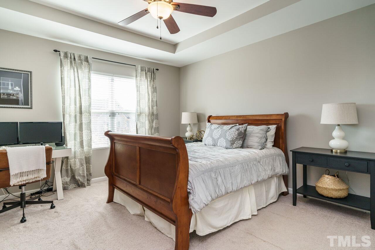 1533 Crafton Way Raleigh, NC 27607 - Photo 18 of 28 a bedroom with a bed and a table in it