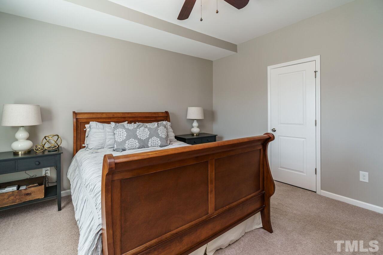 1533 Crafton Way Raleigh, NC 27607 - Photo 19 of 28 a bedroom with bed and a lamp on dresser